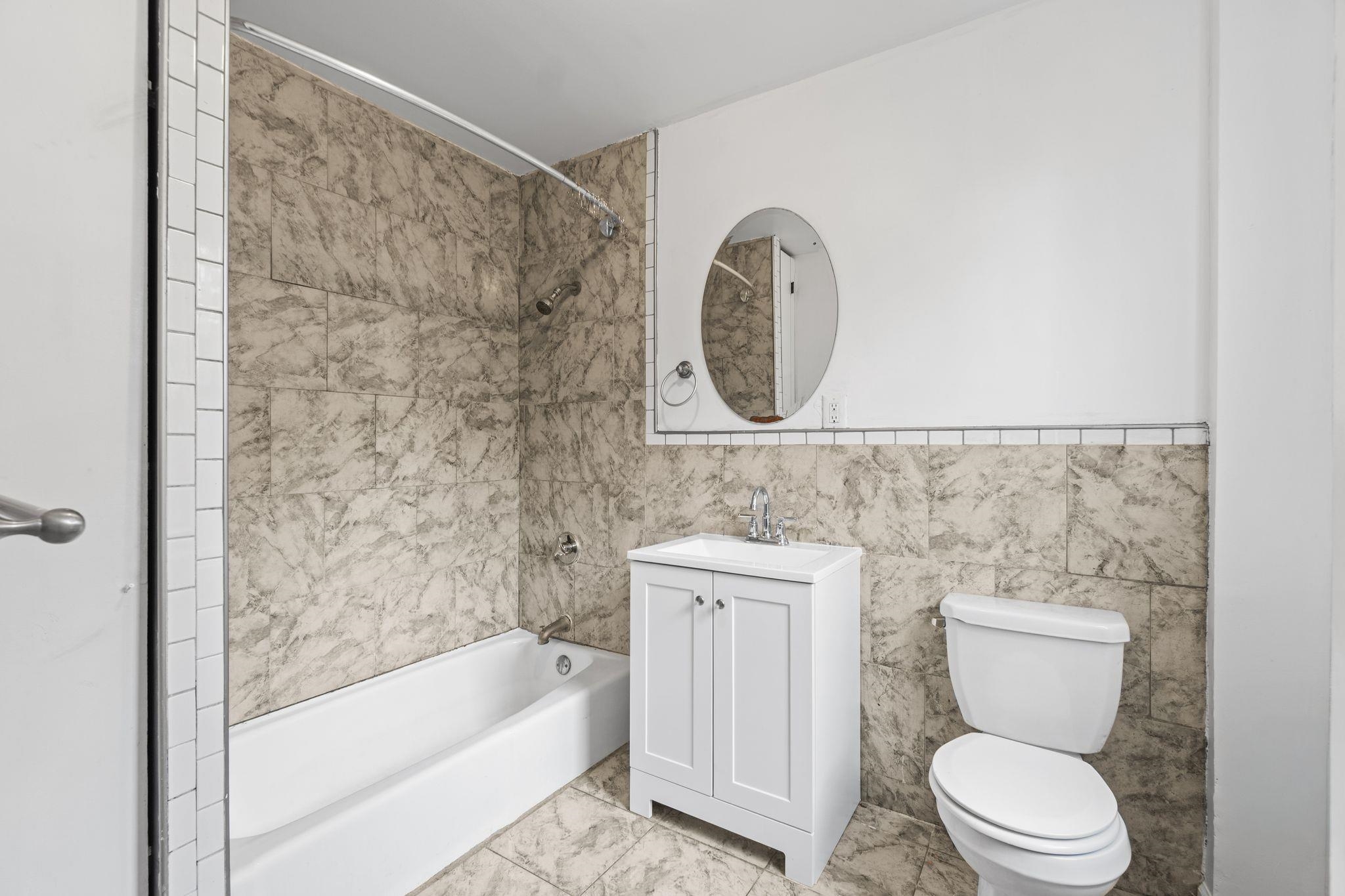 91 Ocean Avenue, Unit 3 Jersey City, NJ 07305 - Photo 10 of 14 a bathroom with a toilet and a bathtub