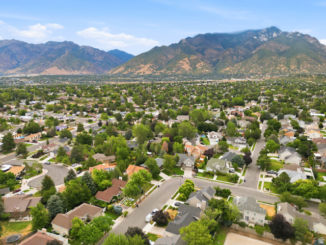 2073 Village Point Way Sandy, UT 84093 - Photo 67 of 68 Expansive residential area with varied home styles, mature trees, and a mountain backdrop