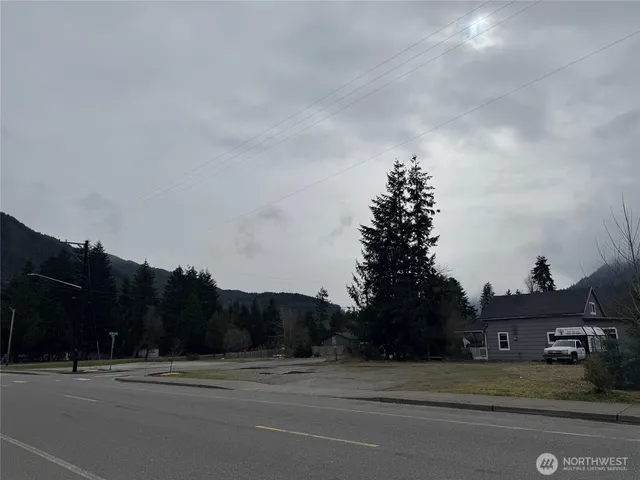 a view of a building and car parked on the road