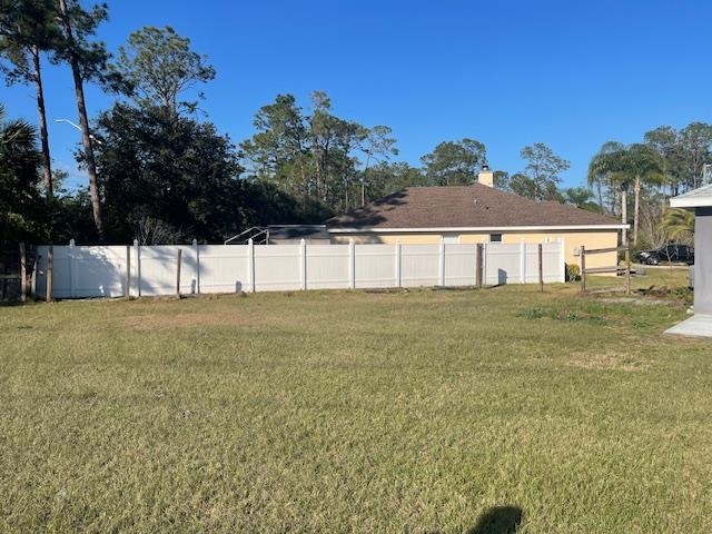 14 Random Place Palm Coast, FL 32164 - Photo 21 of 25 a view of a house with a yard