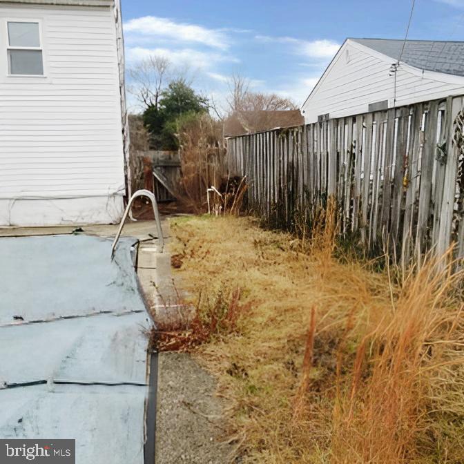718 Mayo Road Glen Burnie, MD 21061 - Photo 34 of 48 Overgrown yard with a covered pool.