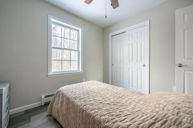 a bathroom with a granite countertop toilet a sink and a mirror