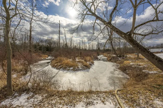 a backyard of a house with table and chairs