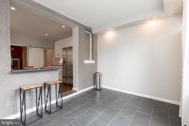 a view of a kitchen with a sink and a refrigerator