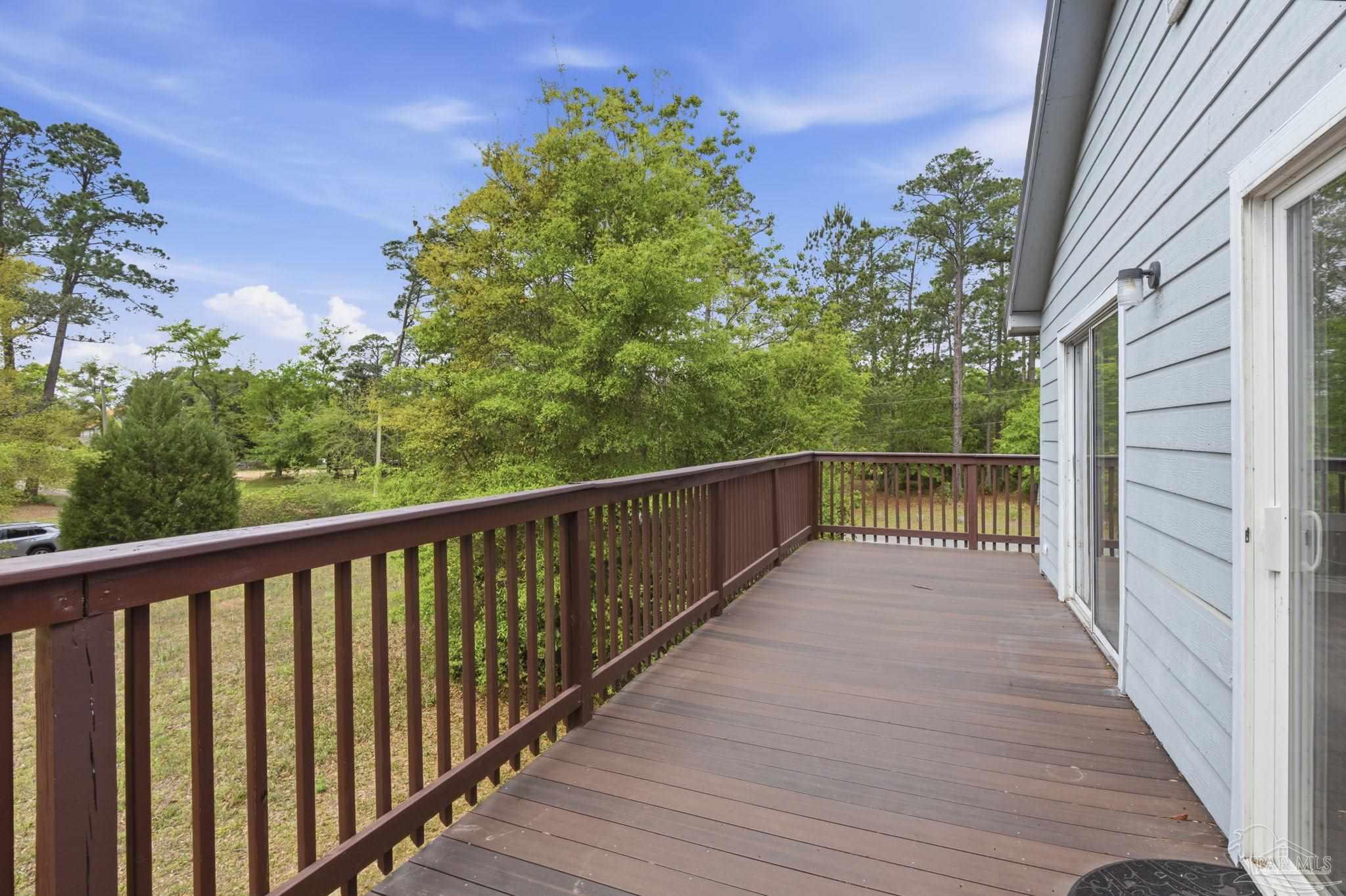 4032 Mae Lane Milton, FL 32583 - Photo 11 of 50 a view of balcony with wooden floor and fence