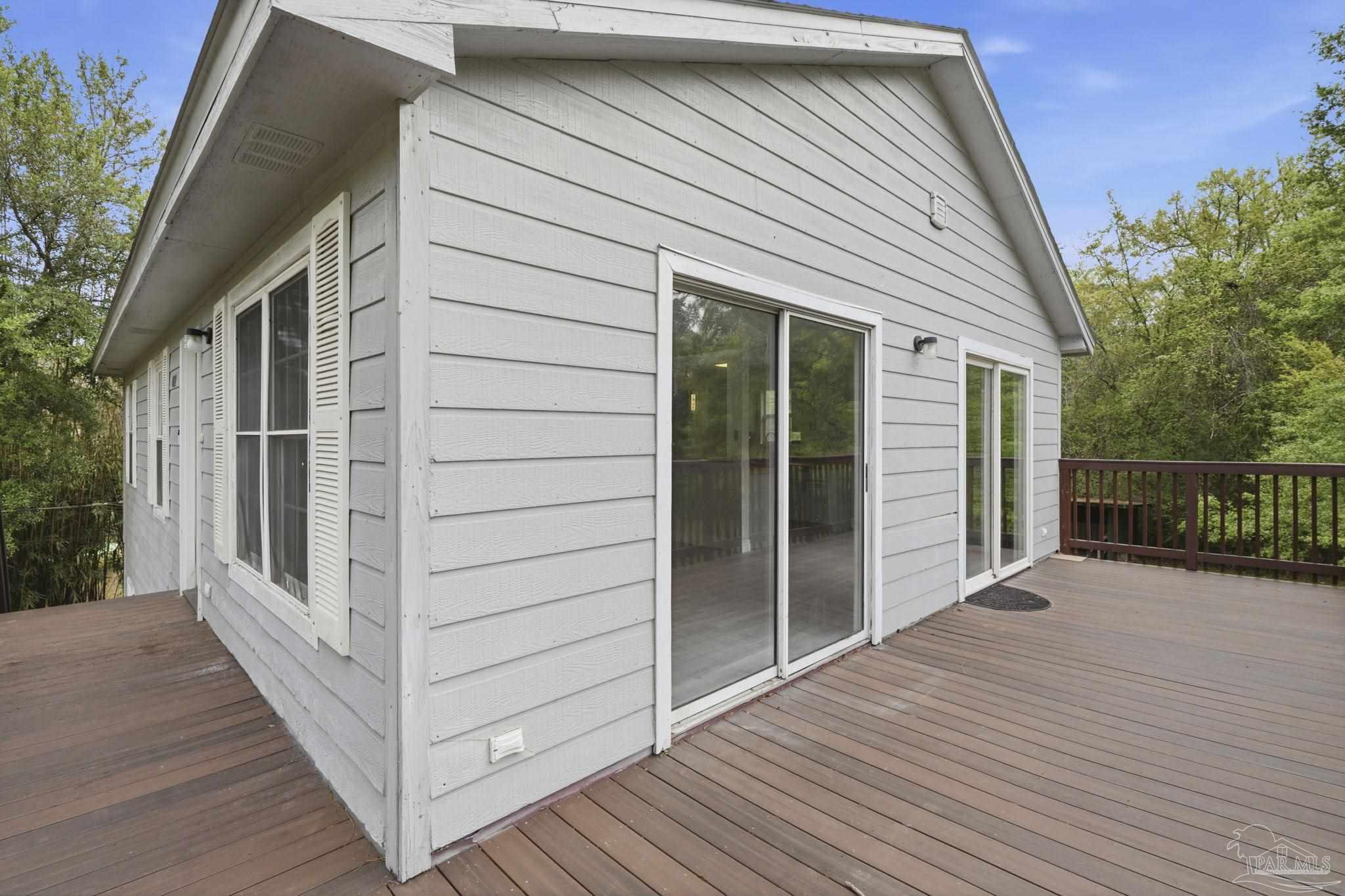 4032 Mae Lane Milton, FL 32583 - Photo 12 of 50 a view of a house with wooden deck