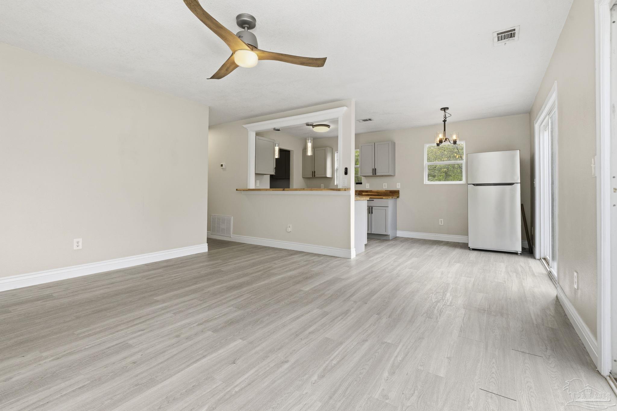 4032 Mae Lane Milton, FL 32583 - Photo 15 of 50 a view of a kitchen with wooden floor and electronic appliances
