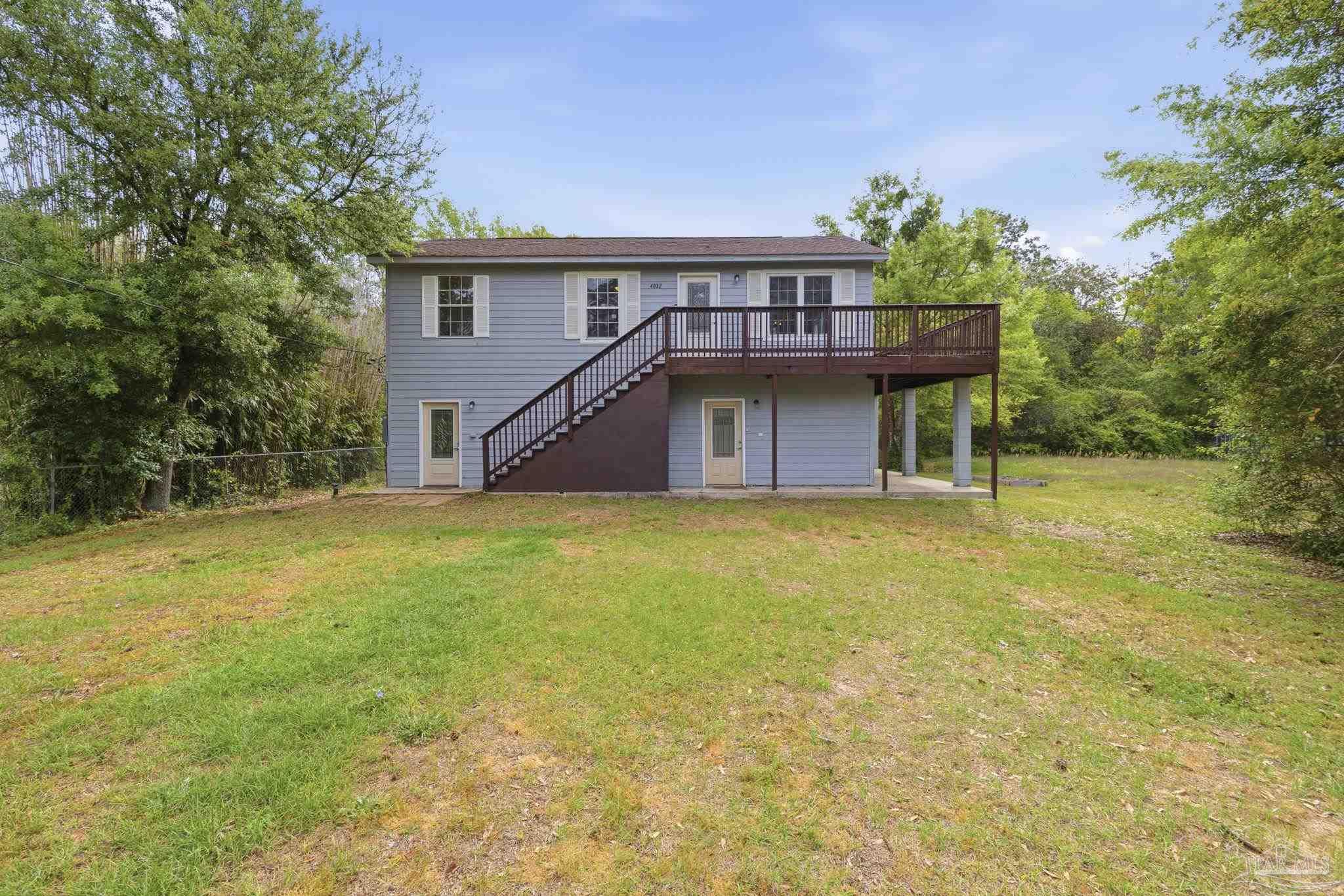 4032 Mae Lane Milton, FL 32583 - Photo 2 of 50 a view of a house with a backyard and plants