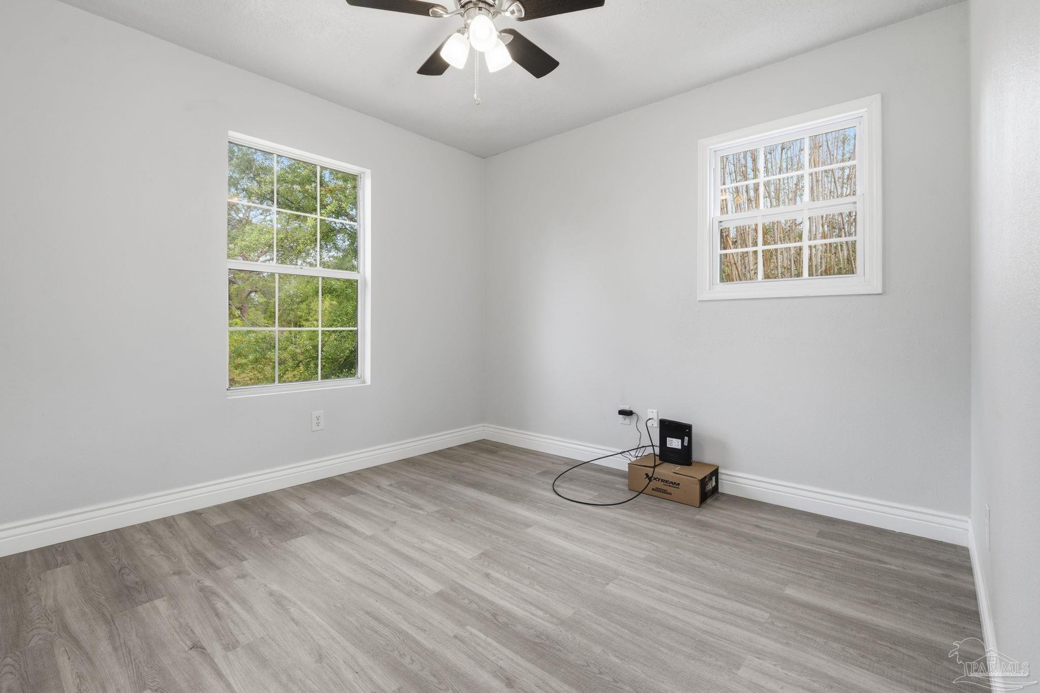 4032 Mae Lane Milton, FL 32583 - Photo 25 of 50 a view of a room with wooden floor and a window