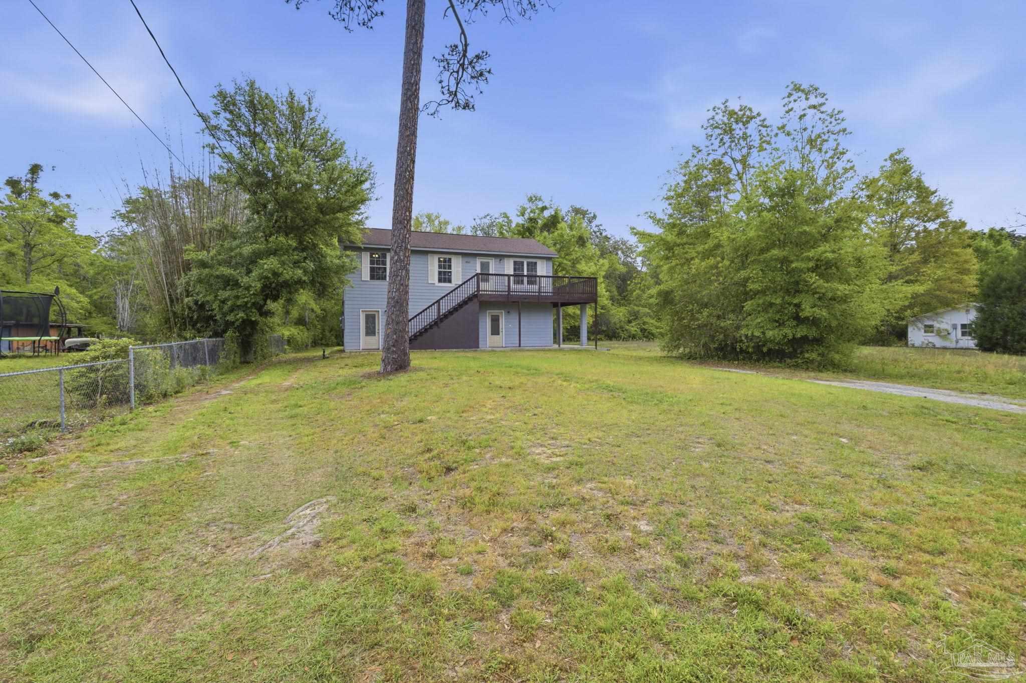 4032 Mae Lane Milton, FL 32583 - Photo 3 of 50 a view of a house with a yard