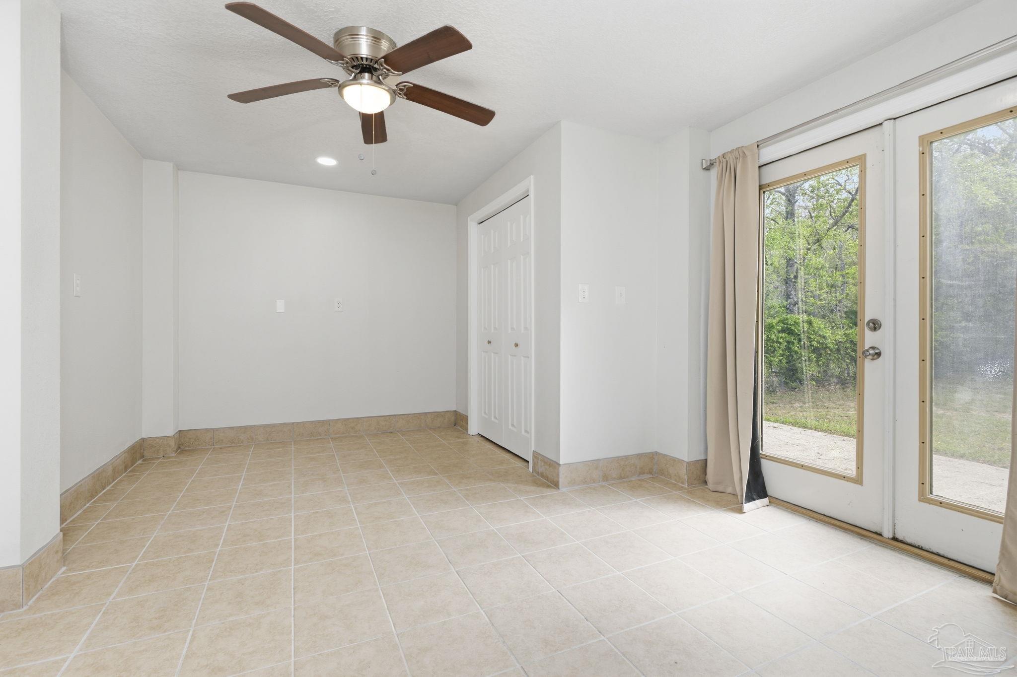 4032 Mae Lane Milton, FL 32583 - Photo 32 of 50 an empty room with fan and windows