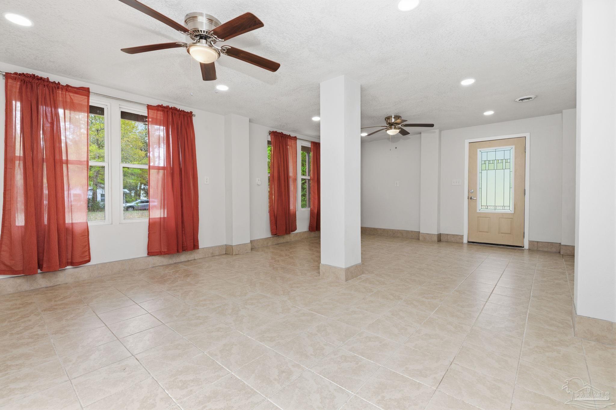 4032 Mae Lane Milton, FL 32583 - Photo 34 of 50 an empty room with ceiling fan and windows