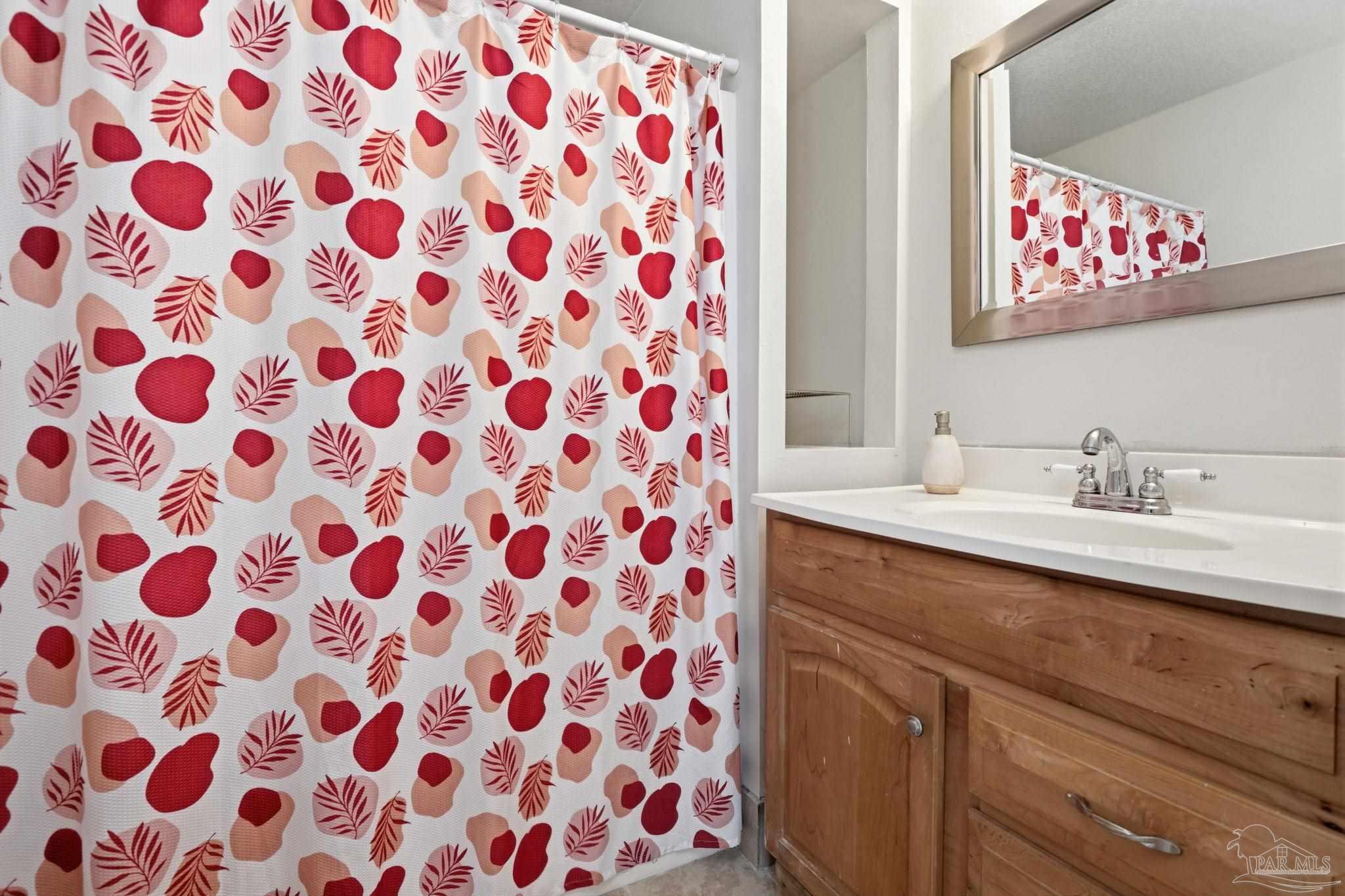 4032 Mae Lane Milton, FL 32583 - Photo 37 of 50 a bathroom with a sink a mirror and shower curtain