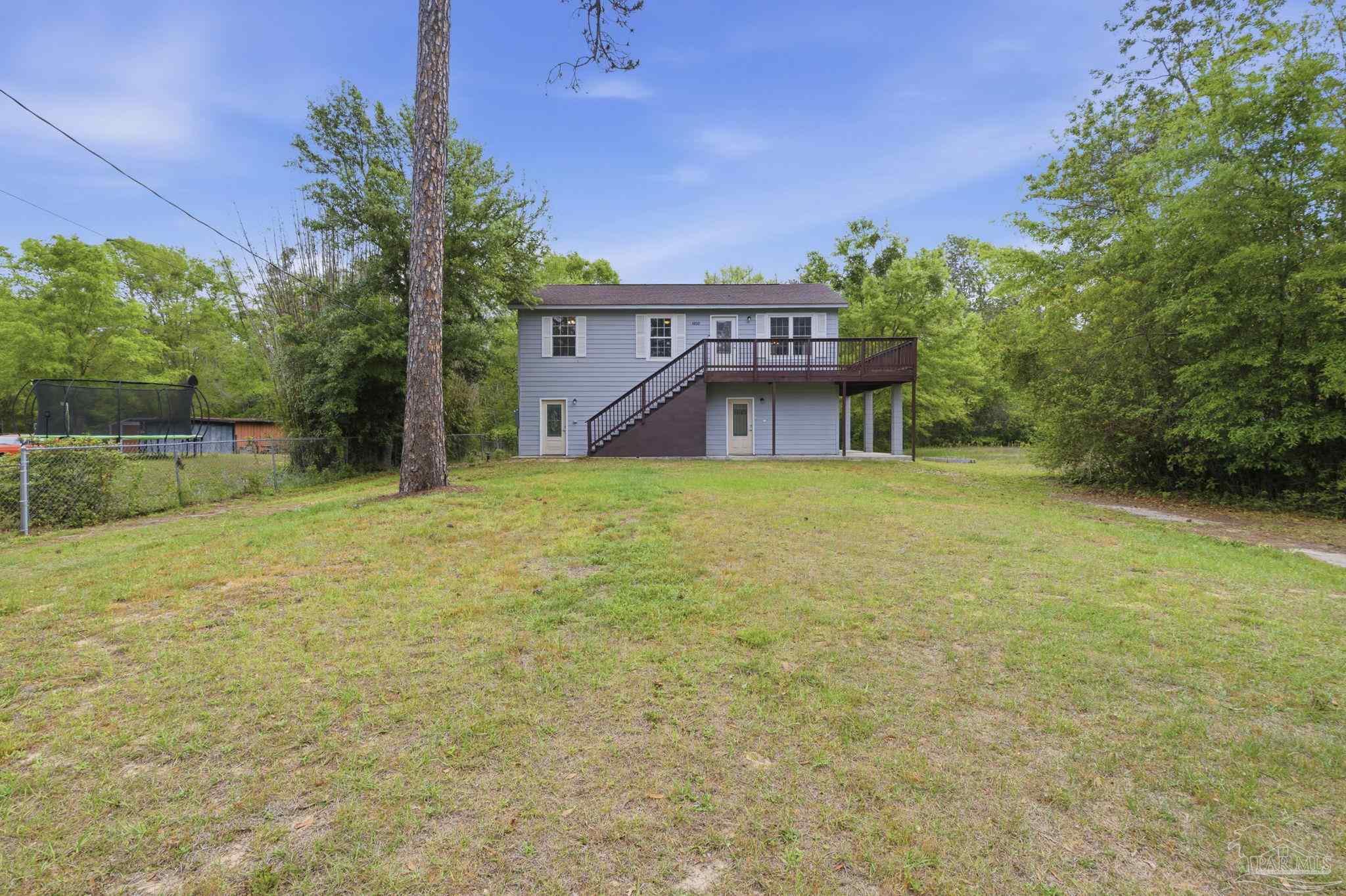 4032 Mae Lane Milton, FL 32583 - Photo 4 of 50 a view of a house with a yard