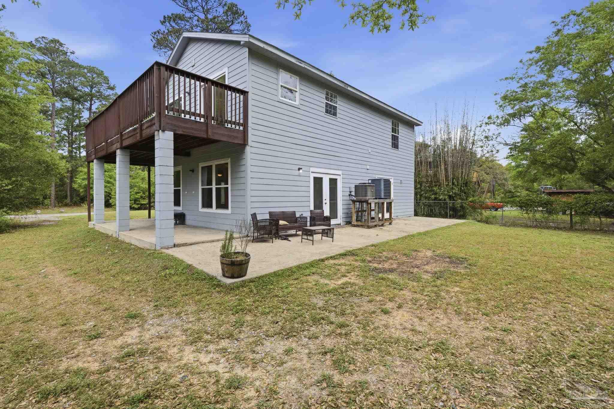 4032 Mae Lane Milton, FL 32583 - Photo 7 of 50 a view of a house with backyard and sitting area