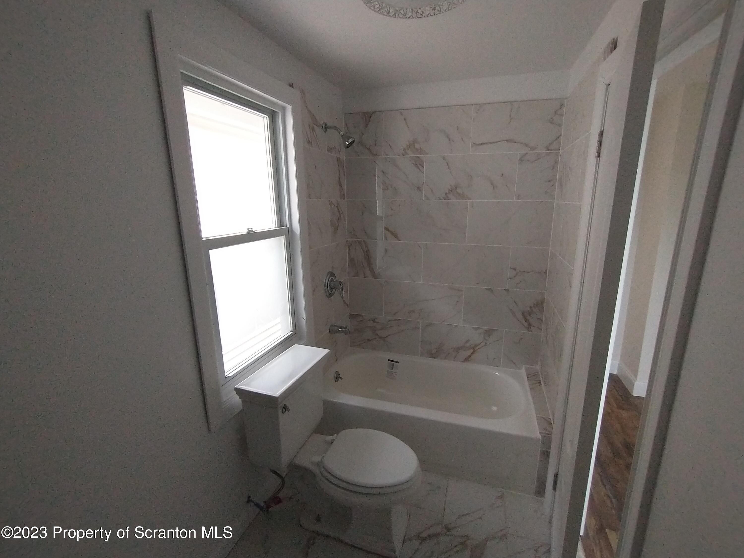 1604 Hawthorne Street Scranton, PA 18504 - Photo 11 of 11 a bath room with a toilet and a bath tub