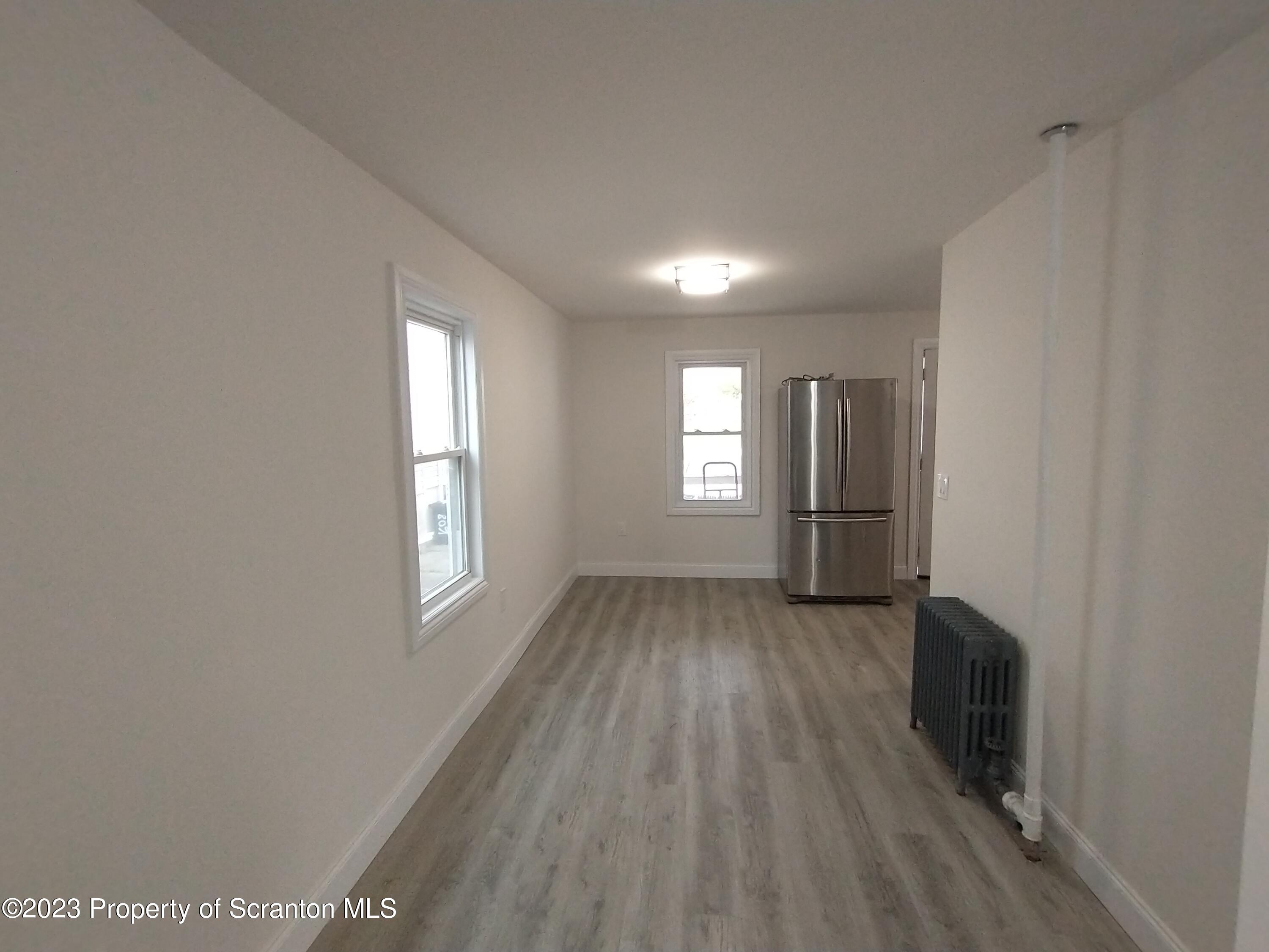 1604 Hawthorne Street Scranton, PA 18504 - Photo 3 of 11 a view of an empty room with wooden floor and a window