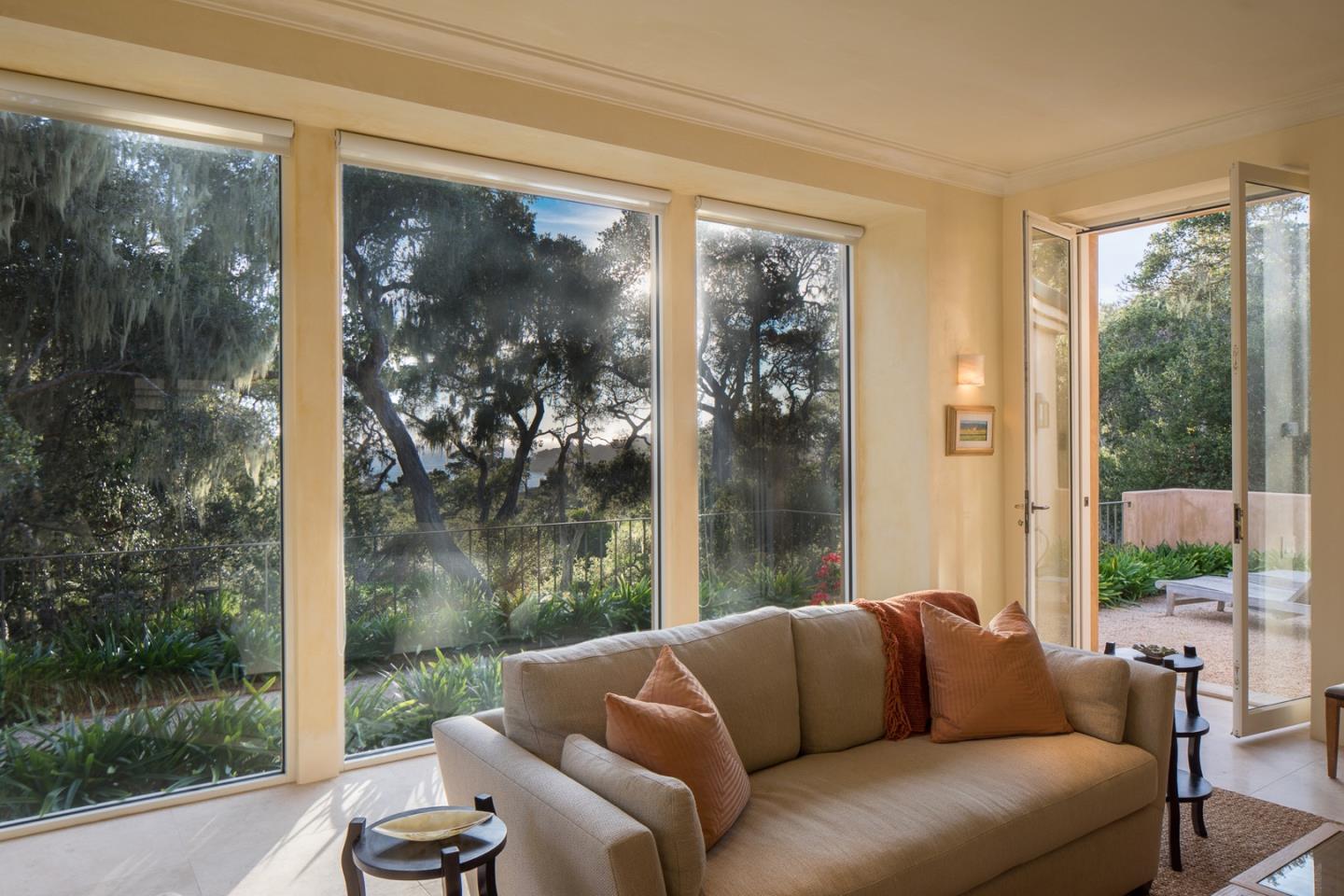 1552 Riata Road Pebble Beach, CA 93953 - Photo 8 of 32 a living room with couch and a floor to ceiling window