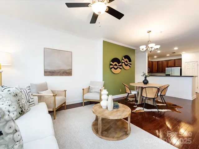 a living room with furniture and a chandelier
