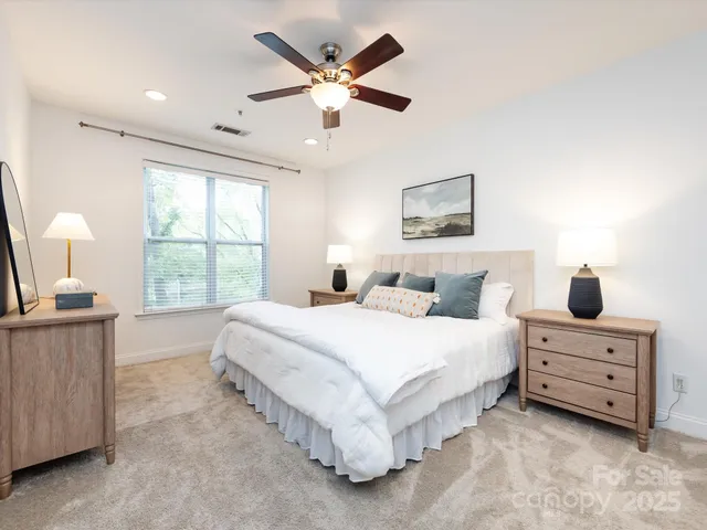 a spacious bedroom with a bed and window