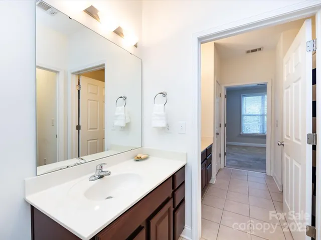 a bathroom with a sink a mirror and a shower