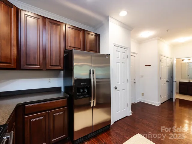 a kitchen with granite countertop wooden cabinets and stainless steel appliances