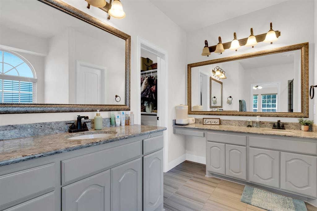 129 Micco Lane Fate, TX 75087 - Photo 12 of 31 a bathroom with a granite countertop sink vanity and mirror
