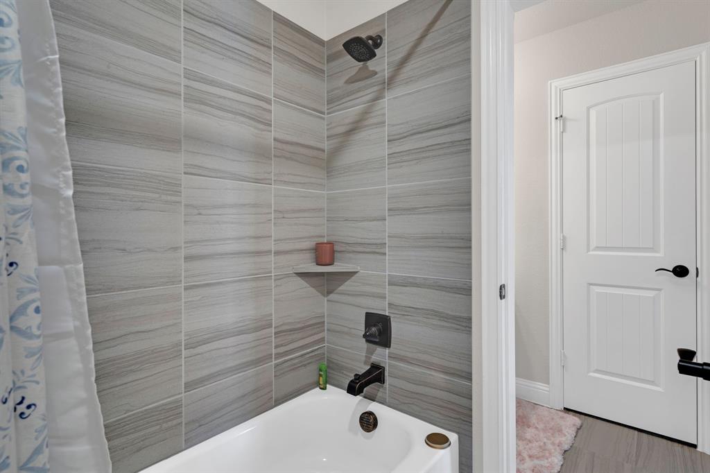 129 Micco Lane Fate, TX 75087 - Photo 17 of 31 a bathroom with a bathtub and shower