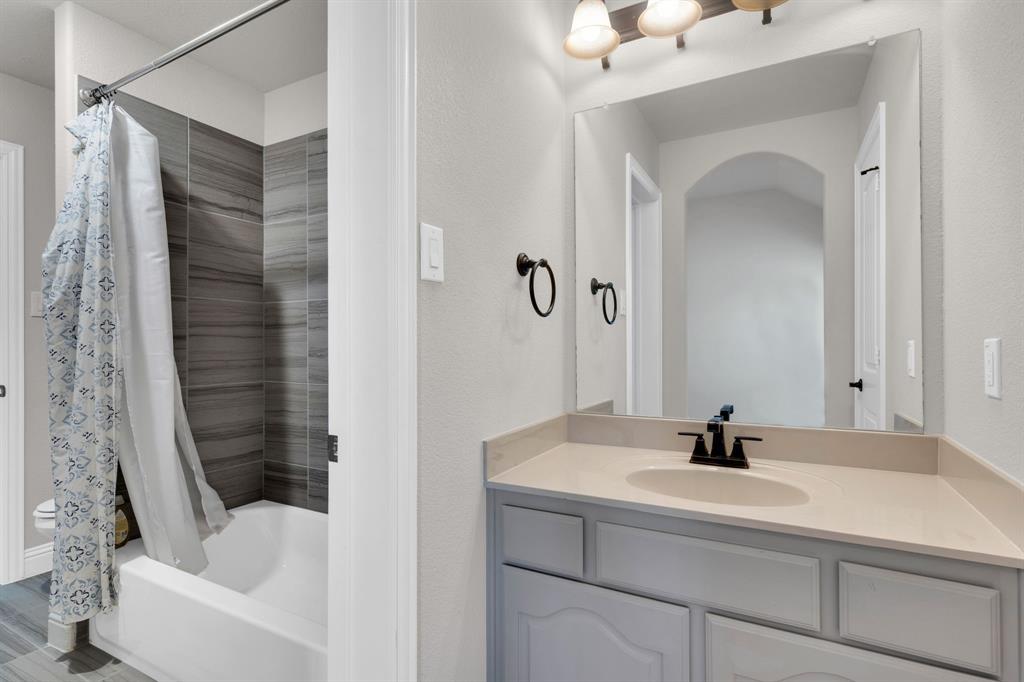 129 Micco Lane Fate, TX 75087 - Photo 19 of 31 a bathroom with a sink and a bathtub