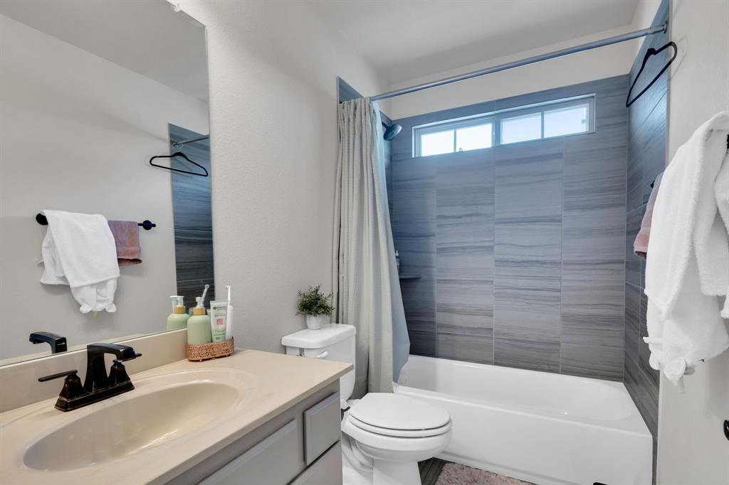 129 Micco Lane Fate, TX 75087 - Photo 21 of 31 a bathroom with a sink a toilet and shower