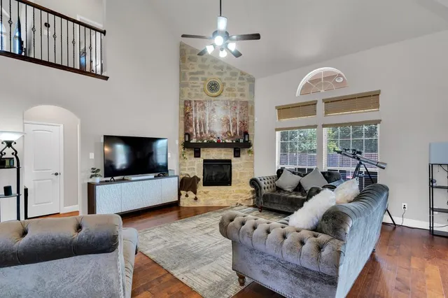 a living room with furniture a fireplace and a flat screen tv