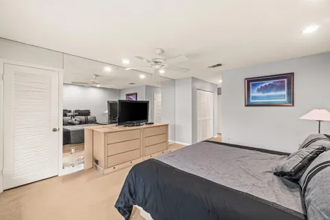 a bedroom with a bed and a television