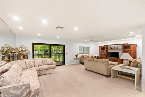 a living room with furniture large window and a fireplace