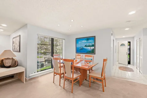 a view of a dining room with furniture and window