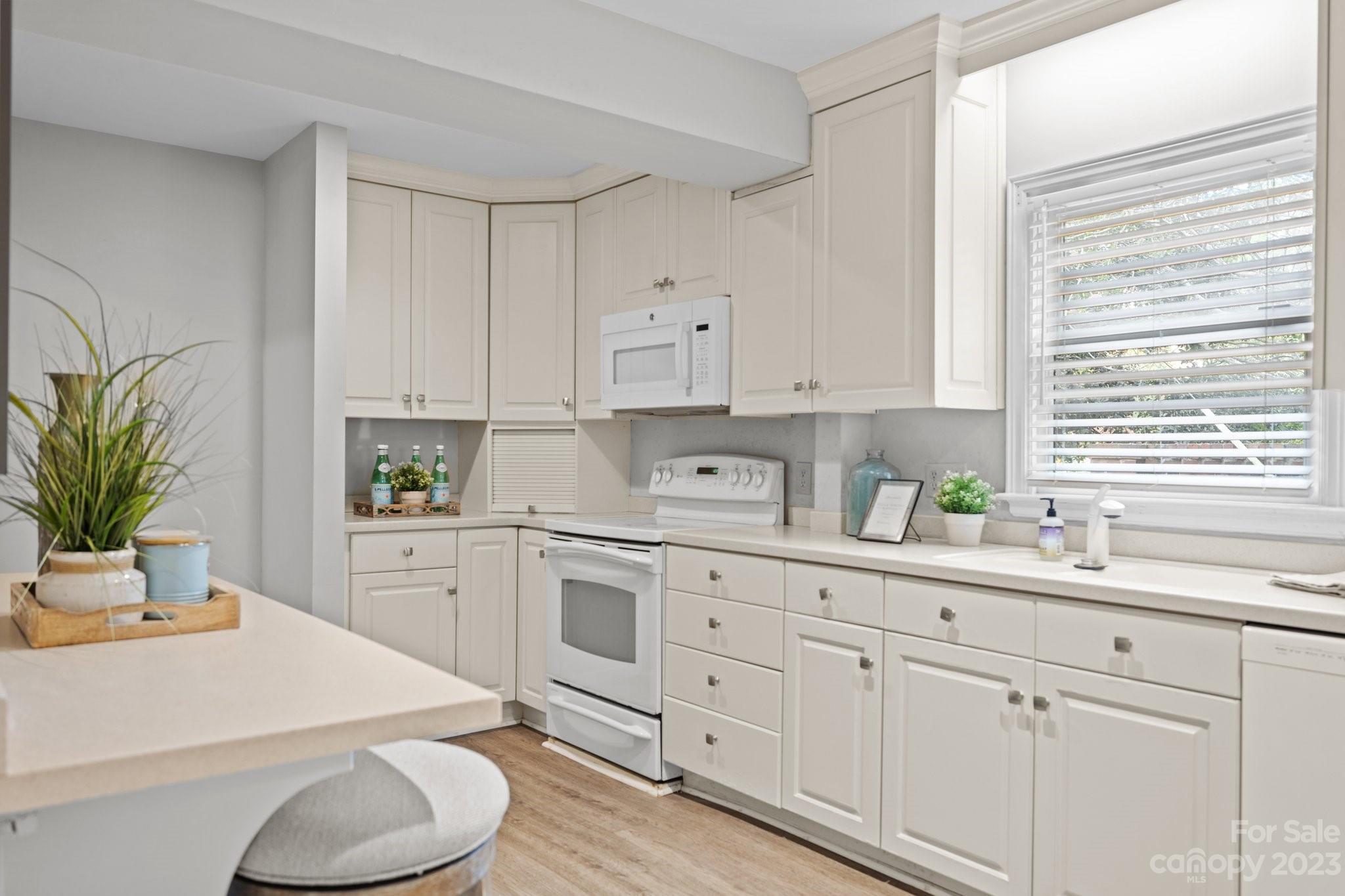 312 Brandywine Road Charlotte, NC 28209 - Photo 13 of 31 a kitchen with white cabinets and white appliances