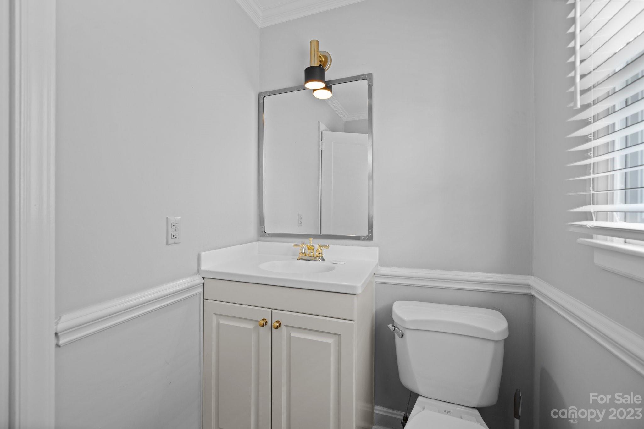 312 Brandywine Road Charlotte, NC 28209 - Photo 16 of 31 a bathroom with a toilet sink vanity and mirror