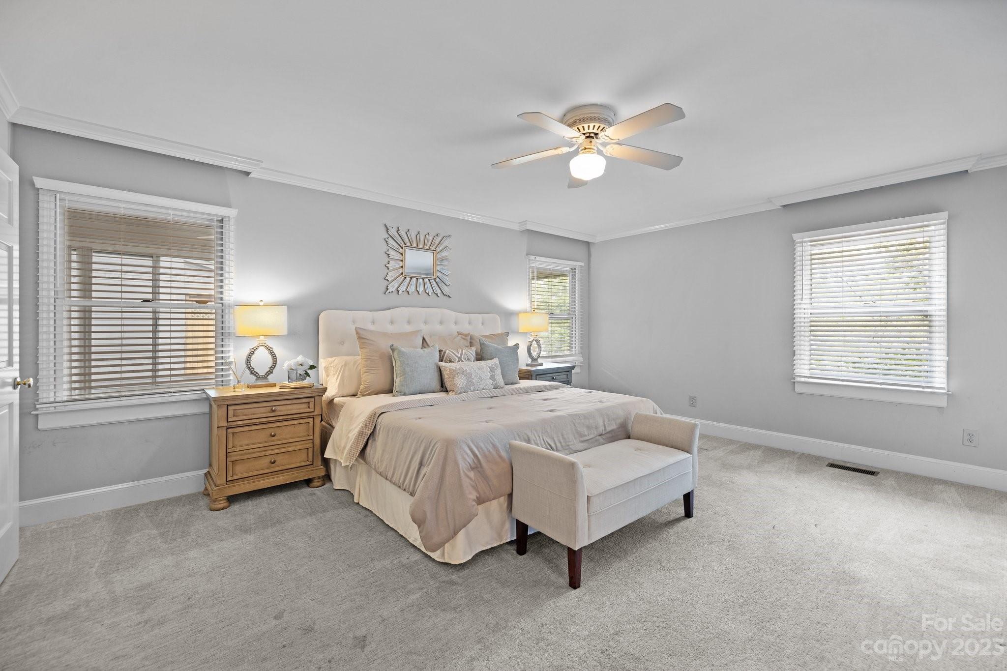 312 Brandywine Road Charlotte, NC 28209 - Photo 18 of 31 a spacious bedroom with a bed and a chandelier