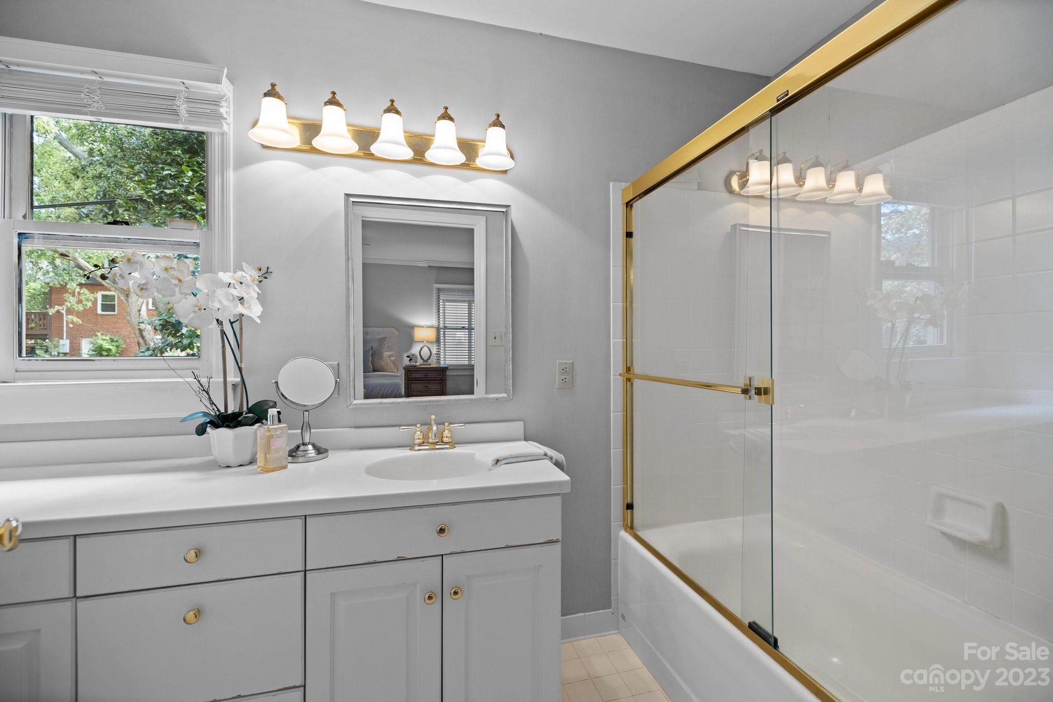 312 Brandywine Road Charlotte, NC 28209 - Photo 19 of 31 a bathroom with a sink mirror and a shower