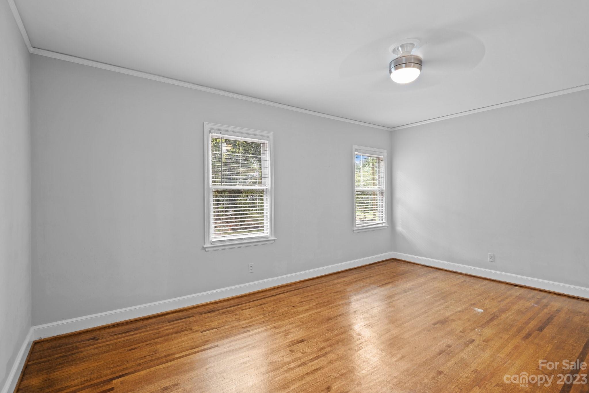 312 Brandywine Road Charlotte, NC 28209 - Photo 22 of 31 a view of an empty room with wooden floor and a window