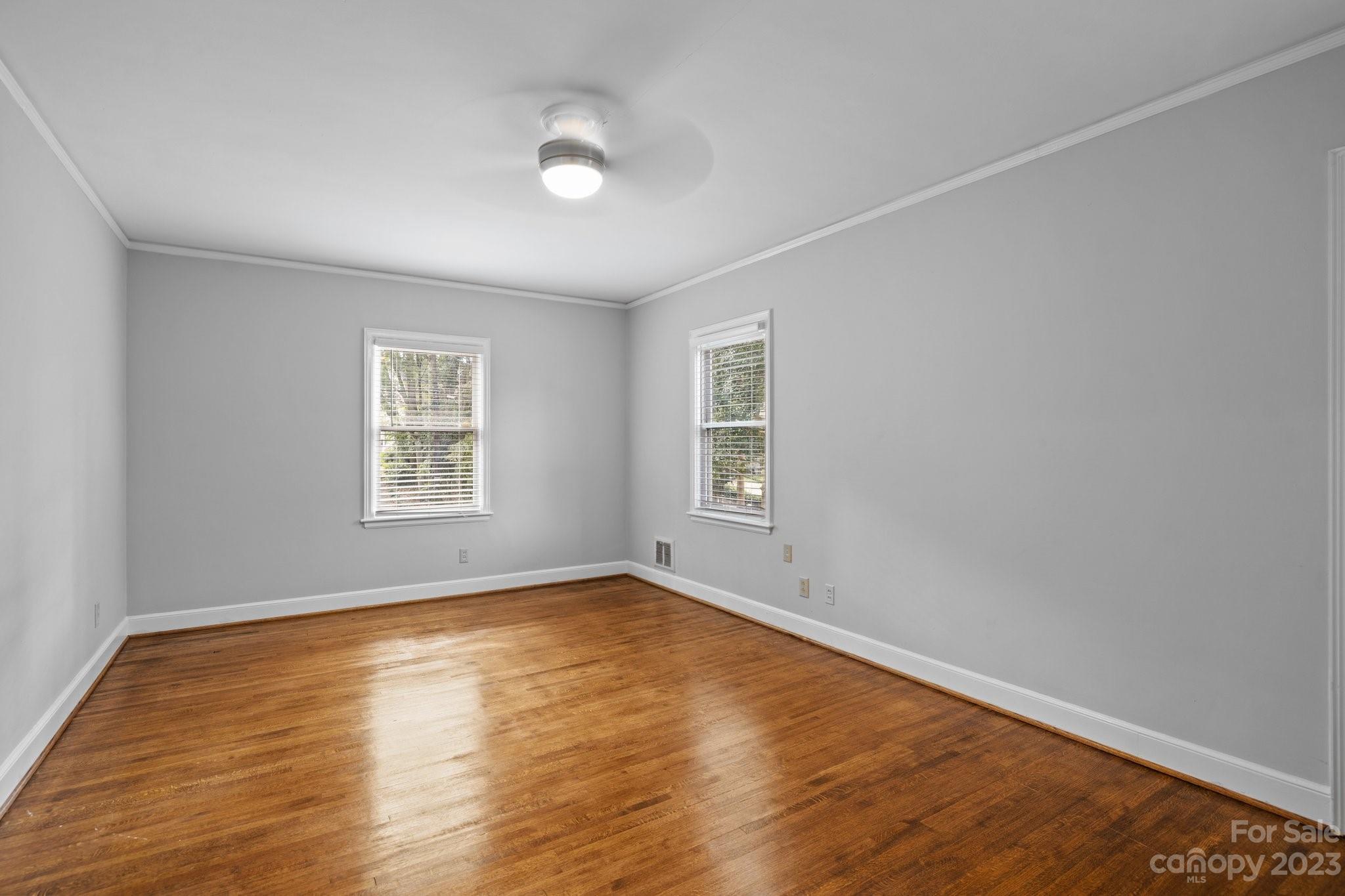 312 Brandywine Road Charlotte, NC 28209 - Photo 23 of 31 an empty room with wooden floor and windows