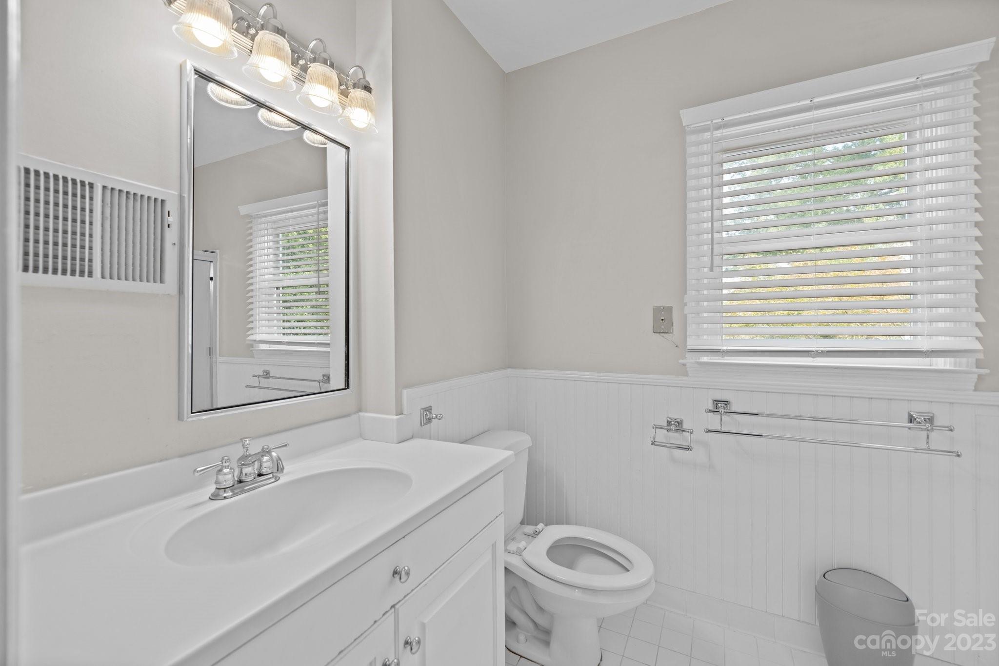 312 Brandywine Road Charlotte, NC 28209 - Photo 24 of 31 a bathroom with a sink a toilet and a mirror