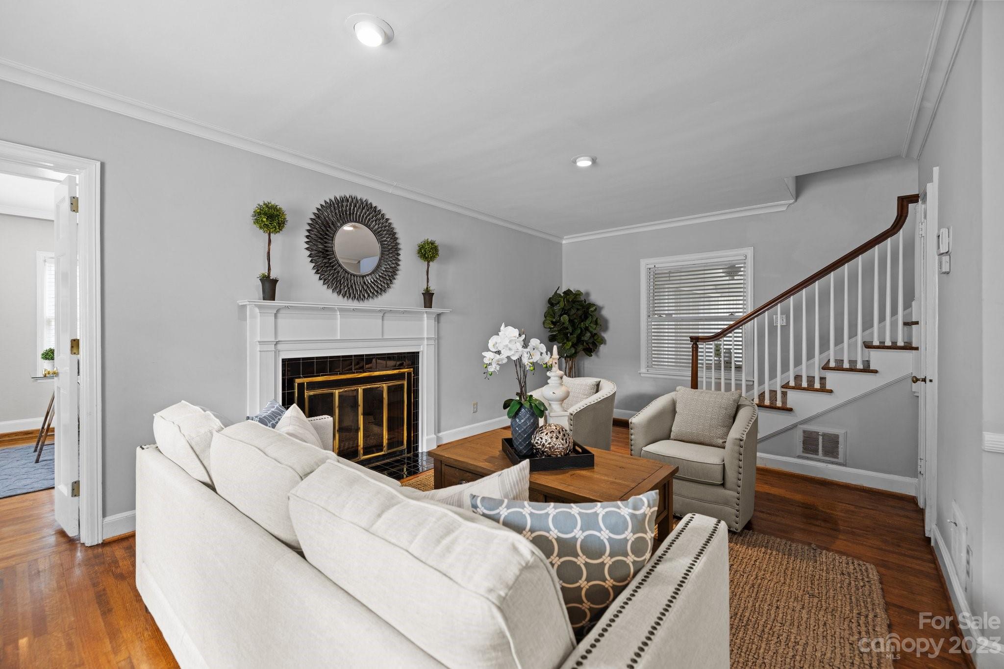 312 Brandywine Road Charlotte, NC 28209 - Photo 5 of 31 a living room with furniture a fireplace and a potted plant