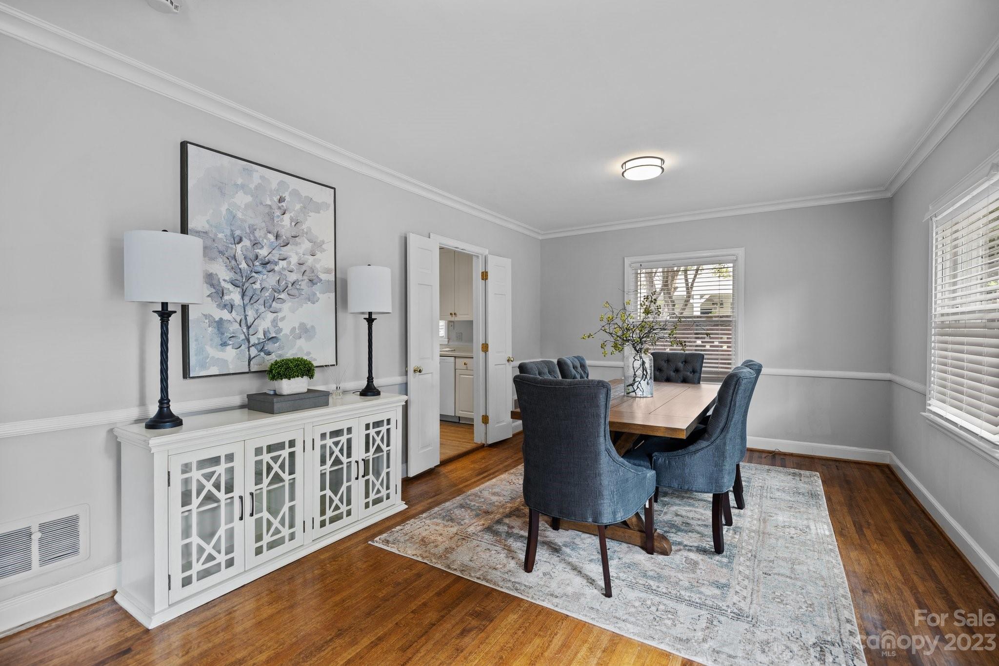312 Brandywine Road Charlotte, NC 28209 - Photo 9 of 31 a dining room with furniture a rug a potted plant and wooden floor