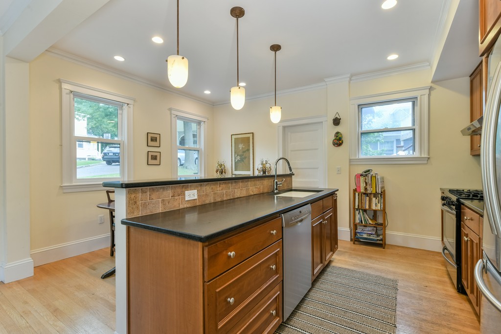 78 Windsor Road, Unit 1 Brookline, MA 02445 - Photo 3 of 11 a kitchen with stainless steel appliances granite countertop a sink a stove top oven a counter space and wooden floor