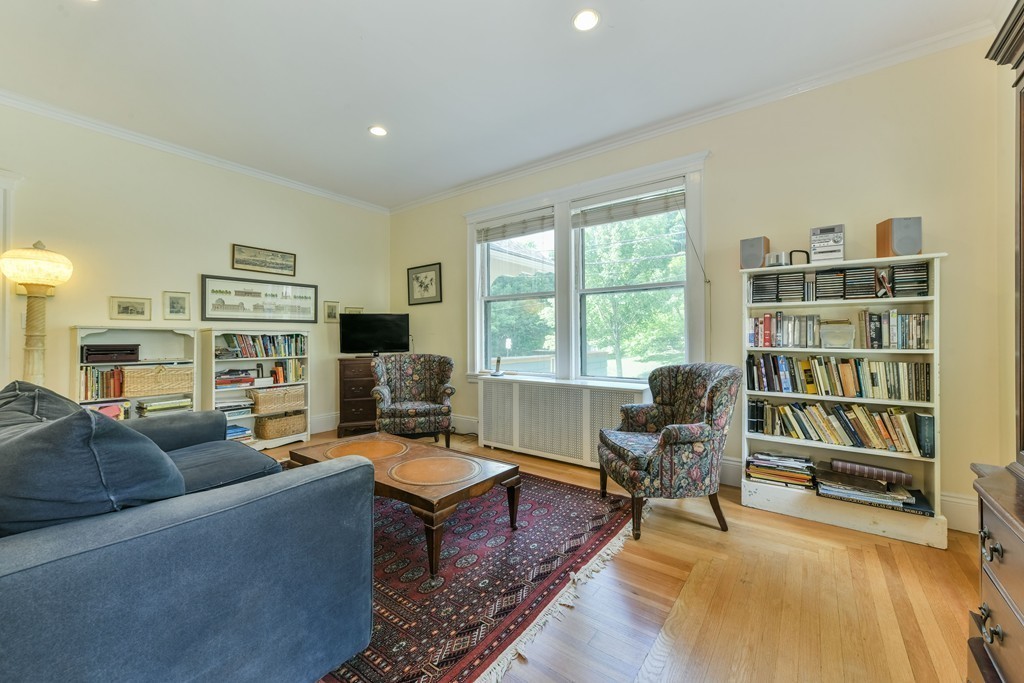 78 Windsor Road, Unit 1 Brookline, MA 02445 - Photo 4 of 11 a living room with furniture bookshelf and a flat screen tv