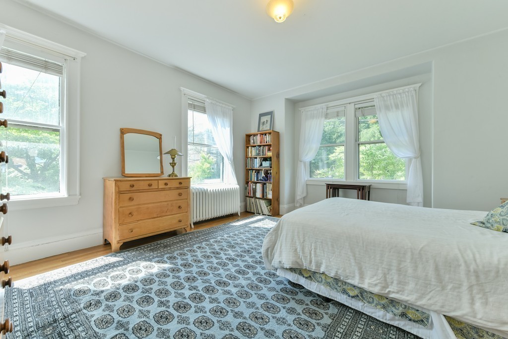 78 Windsor Road, Unit 1 Brookline, MA 02445 - Photo 8 of 11 a bedroom with a bed and a large window