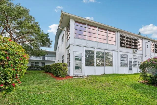 front view of a house with a garden