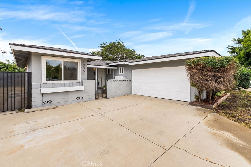 13361 Roxey Drive Garden Grove, CA 92843 - Photo 1 of 31 a front view of a house with a garage