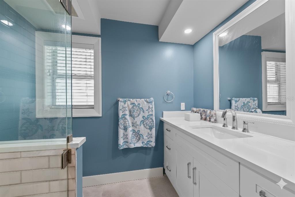 8552 Lagoon Road Fort Myers Beach, FL 33931 - Photo 13 of 33 a bathroom with a sink mirror and a bathtub