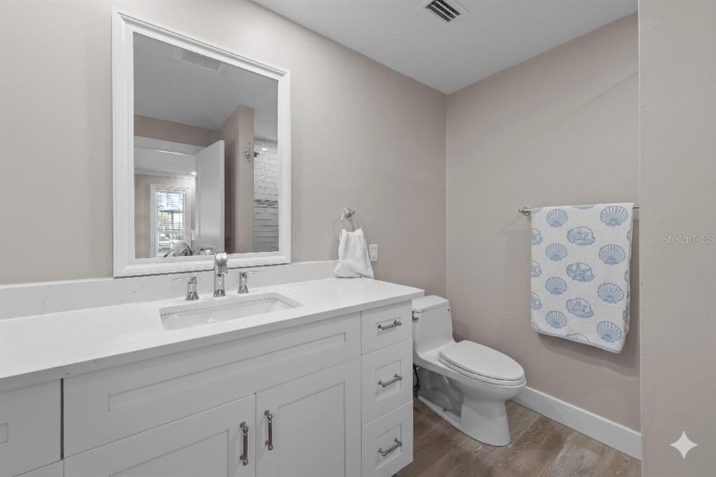 8552 Lagoon Road Fort Myers Beach, FL 33931 - Photo 15 of 33 a spacious bathroom with a toilet sink and mirror